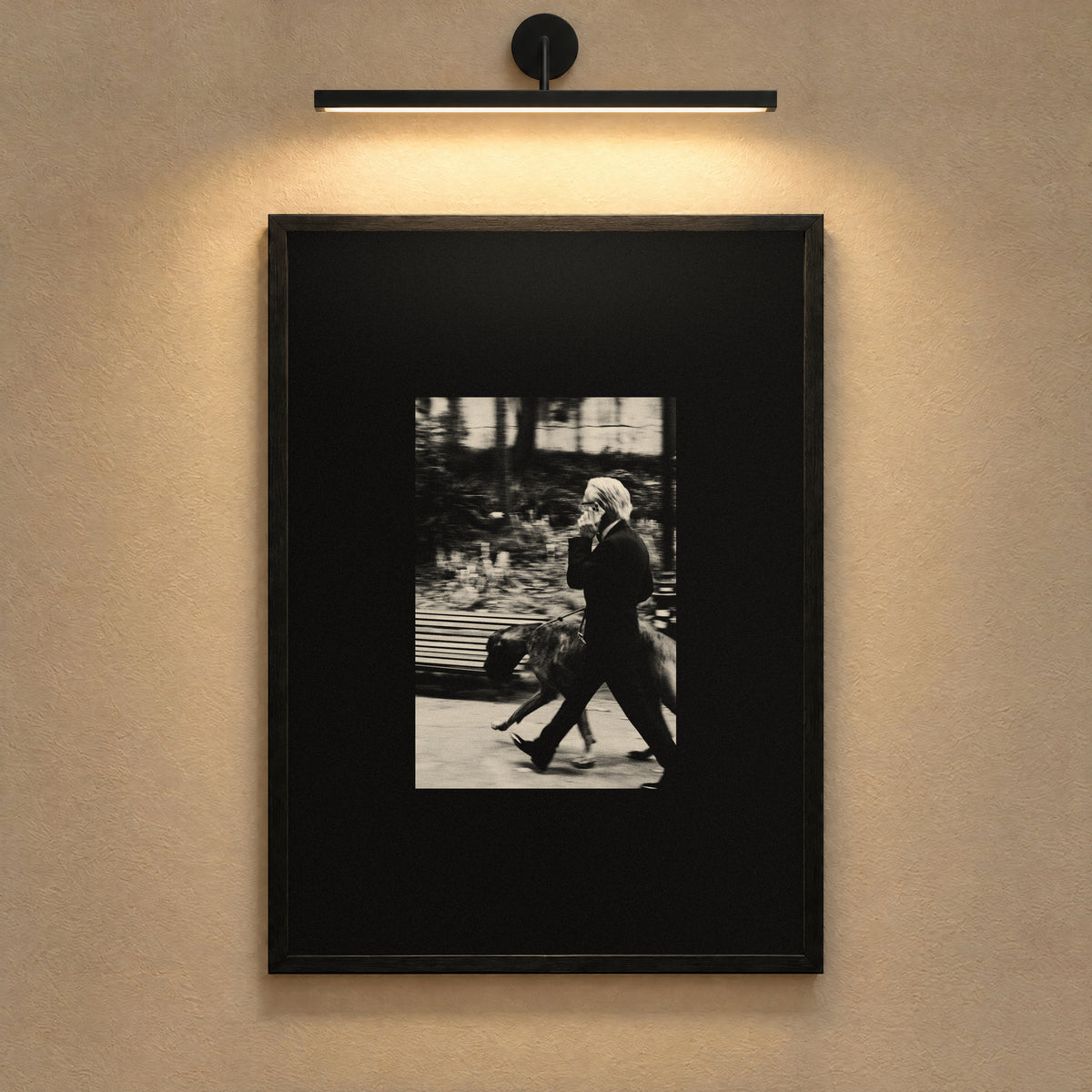 Business as Usual by Lohause, framed black and white print under a gallery picture light
