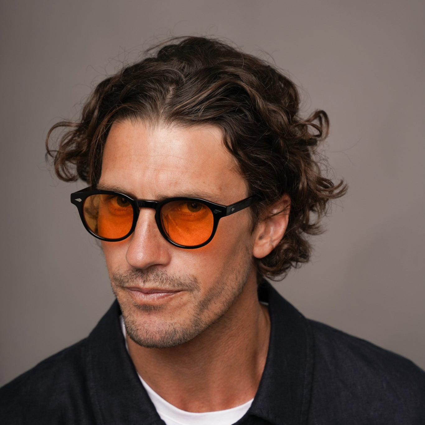 The Basquiat La Vie en Fauve, Mazzucchelli 1849 acetate frame, rounded square shape, black with orange-tinted lenses.