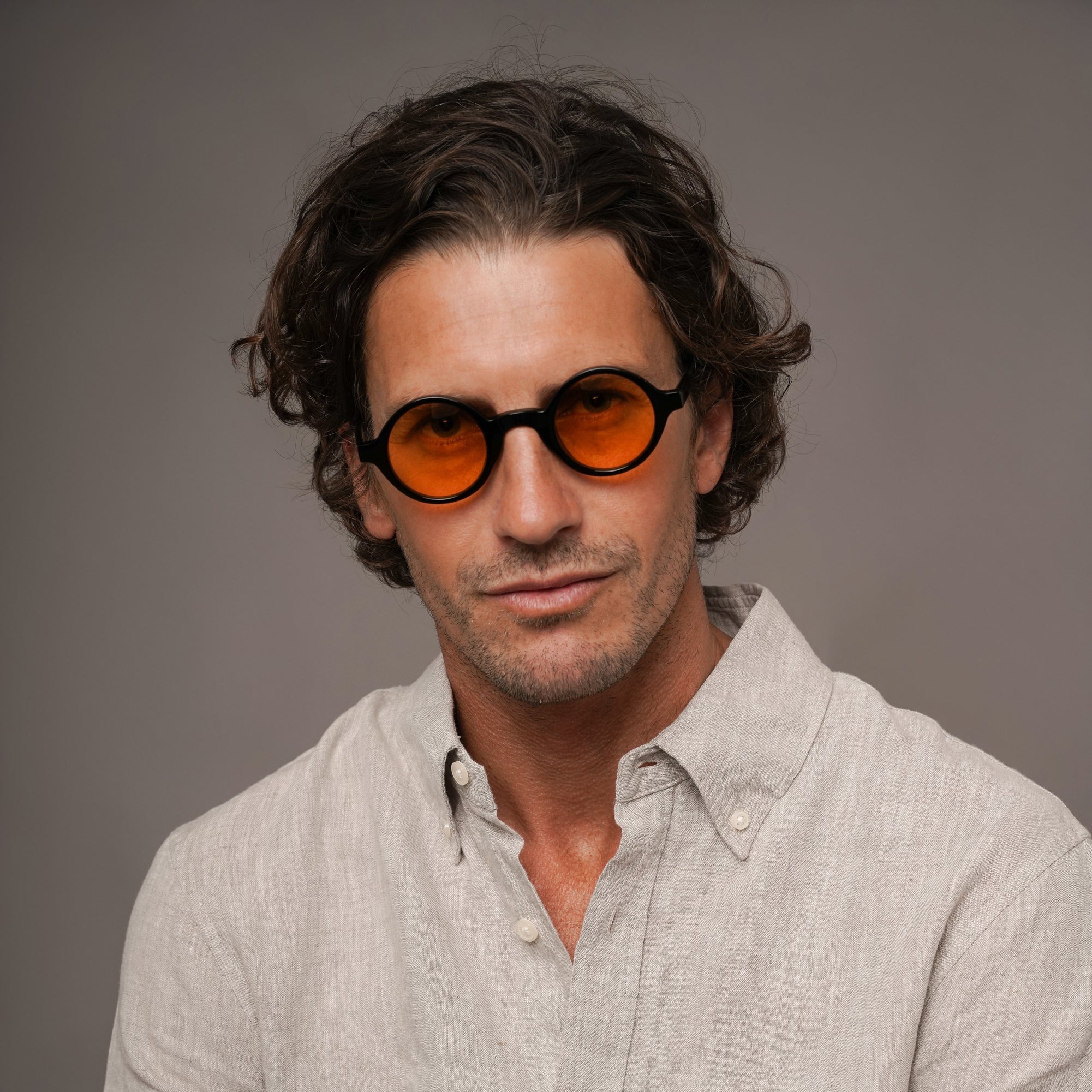 The Winston La Vie en Fauve, Mazzucchelli 1849 acetate frame, round shape, black with orange-tinted lenses.