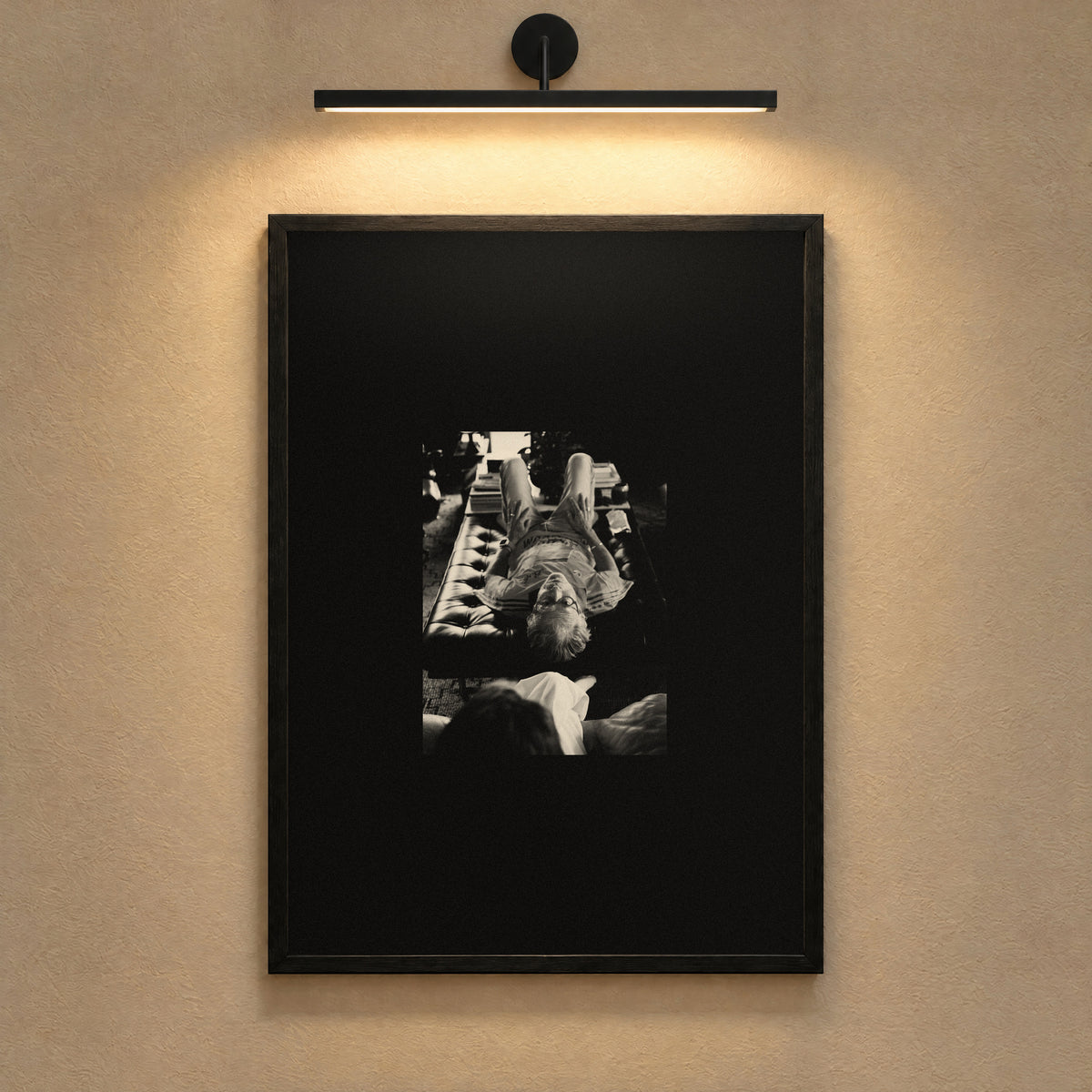 Therapy by Lohause, framed black and white print under a gallery picture light